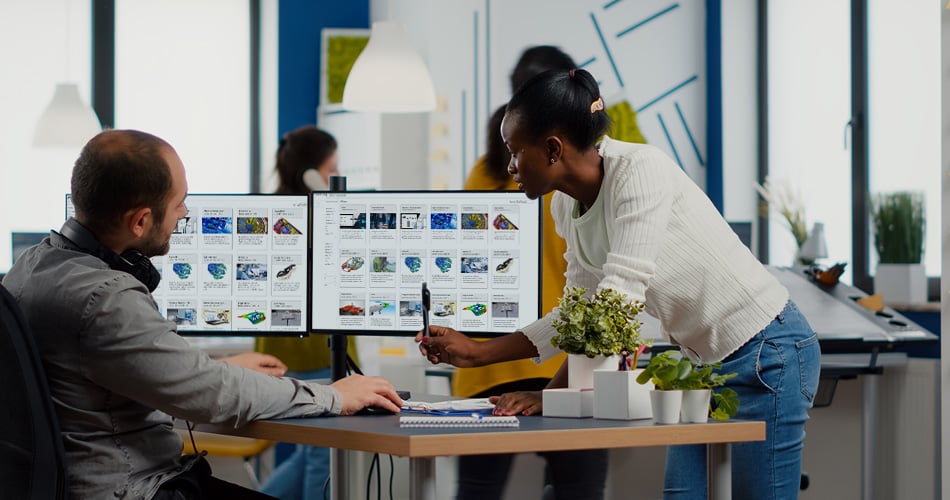 Two engineers browsing software options within the Altair One Marketplace on their office computers.
